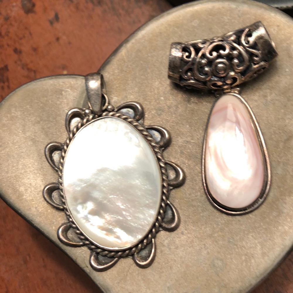 Both pendants are mother of pearl and silver